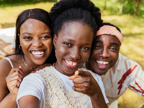 Diverse group of people smiling during a light yoga session.